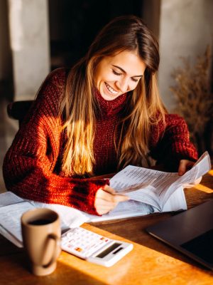 Woman reviewing documents and finances at a table